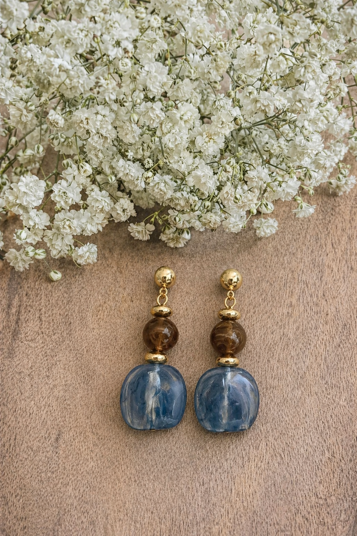 Handcrafted drop earrings featuring rich blue and warm brown tone