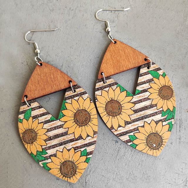 Handcrafted wooden earrings featuring vibrant sunflower designs with delicate striped detailing.